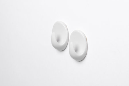 Plastic hanger hooks on white backgroundの写真素材