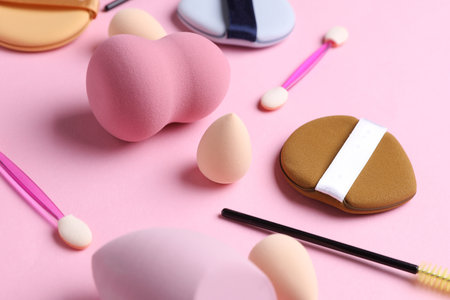 Set of cosmetic sponges blenders for makeup and accessories on pink backgroundの写真素材