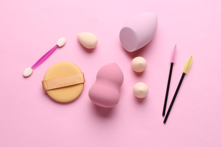 Set of cosmetic sponges blenders for makeup and accessories on pink backgroundの写真素材