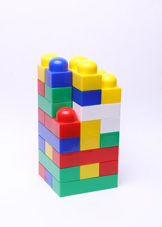 Pyramid with plastic constructor bricks on a white background