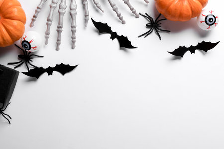Halloween decoration concept. Plastic skeleton hands and decor on white background. Flat layの写真素材