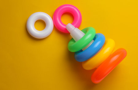 Children's plastic rings on yellow backgroundの写真素材