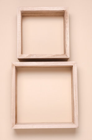 Two square wooden shelves on beige backgroundの写真素材