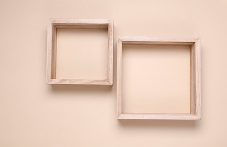 Two square wooden shelves on beige background