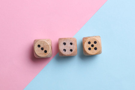 Wooden dice on blue pink pastel backgroundの写真素材