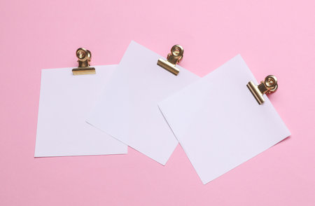 White square memo cards with binders on pink background