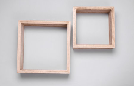 Two square wooden shelves on gray backgroundの写真素材