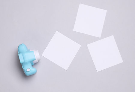Toy plastic camera with blank cards on white backgroundの写真素材