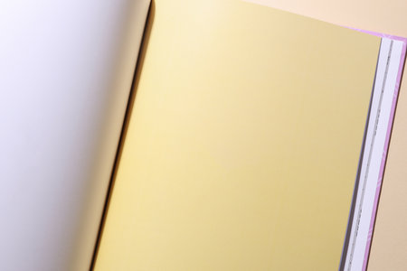 Blank page of open book or magazine on a beige background. Mockup for design