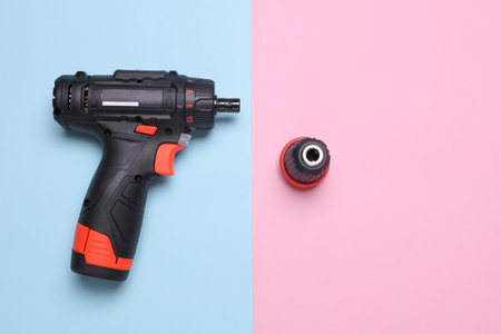Cordless screwdriver on a blue and pink background. Top viewの写真素材