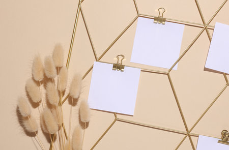 White square memo cards mockups attached to gold grid mood board and lagurus flowers on beige...