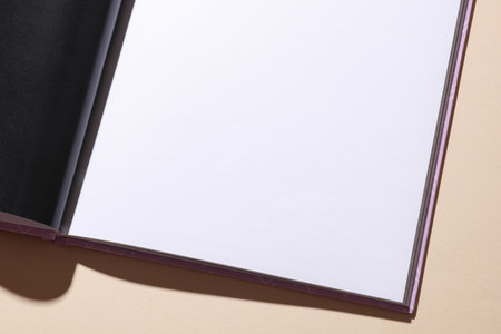 Blank page of open book or magazine on a beige background. Mockup for design
