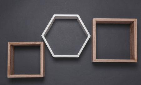 Hexagonal and square wall shelf on dark gray backgroundの写真素材