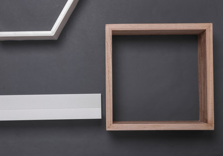 Wall shelves of different shapes on dark gray background