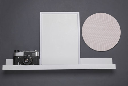 Shelf with empty photo frame and decor. Mockup for design