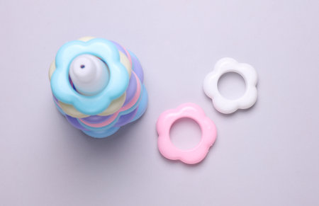 Children's plastic pyramid on a gray background. Top view