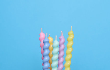 Spiral wax birthday candles on blue backgroundの写真素材