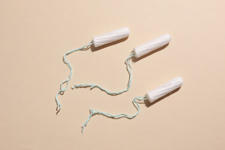 Tampons for feminine intimate hygiene on a beige background. Menstruation, critical days, female cycleの写真素材