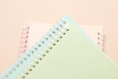 Spiral binding notebooks on beige background