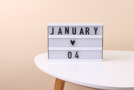 Lightbox calendar with date January 04 on tableの写真素材