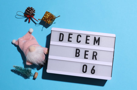 Lightbox calendar with text December 06 with Christmas, New Year winter decor on blue background