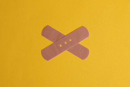 Medical Adhesive bandage plasters on yellow backgroundの写真素材