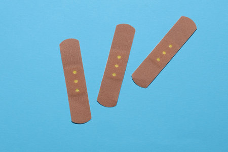 Medical Adhesive bandage plasters on blue backgroundの写真素材