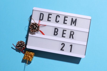Lightbox calendar with text December 21 with Christmas, New Year winter decor on blue background