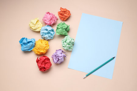 Colored balls of crumpled paper and paper sheet with pencil. Lack of ideas, stress, depression, business conceptの写真素材