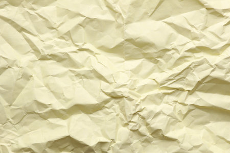 Crumpled yellow paper background texture close upの写真素材