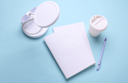 Books, sketchbooks or notebooks with white blank covers on blue background. Mockup for designの写真素材