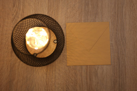Loft lamp illuminates envelope on tableの写真素材