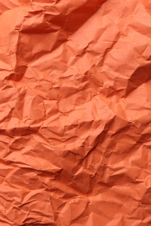 Crumpled orange paper background. Natural textureの写真素材