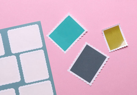 Blank Postal paper adhesive stamps on pink background. Marks for Envelopeの写真素材