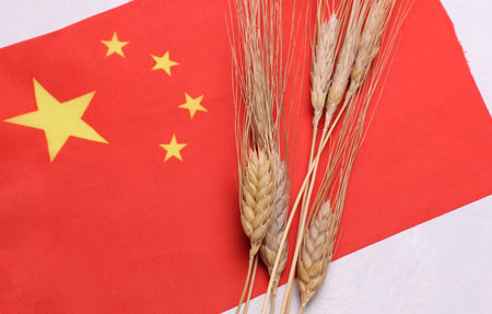 Ears of wheat with China flag. Trade export and economy, grain deal and world food security concept.