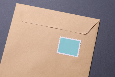 Envelope with postage stamp on dark gray backgroundの写真素材