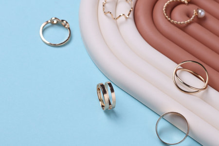 Gold rings of different shapes with geometry podium on white background. Showcase for product presentation. Creative layout. Minimalismの写真素材