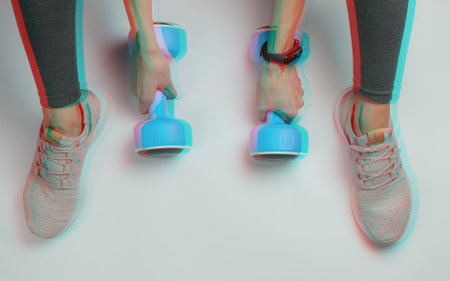 Fitness, sport concept. Woman dressed in leggings and sneakers doing exercise with dumbbells. Glitch effectの写真素材