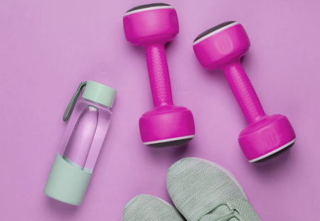 Flat lay style concept of healthy lifestyle, sport and fitness. Sports shoes for running, dumbbells,...