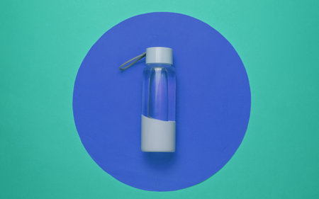 Bottle of water for sports and outdoor activities on blue circle background. Top viewの写真素材