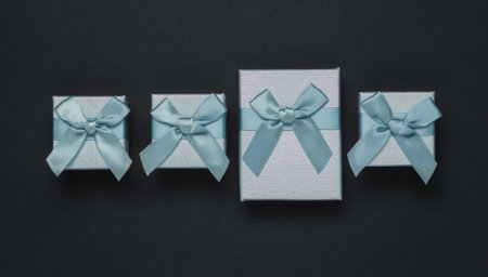 Gift boxes with bow on black background. Composition for Christmas, Black Friday, birthday or wedding.の写真素材