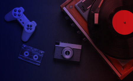 Flat lay retro media and entertainment in neon lightの写真素材