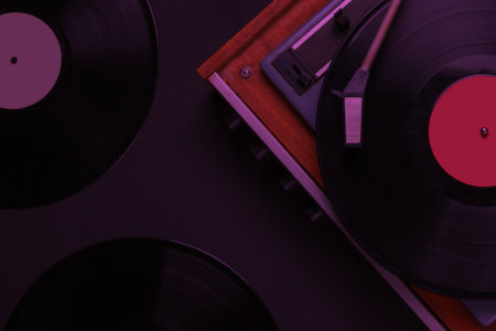 Retro music player. Vinyl record player with a vinyl record in neon light. 70s. Top viewの写真素材