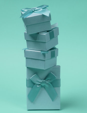 Stack of Gift boxes with bows on blue pastel background. Composition for christmas, birthday or...
