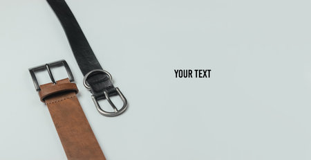 Two leather belts on white background close-up. Copy spaceの写真素材