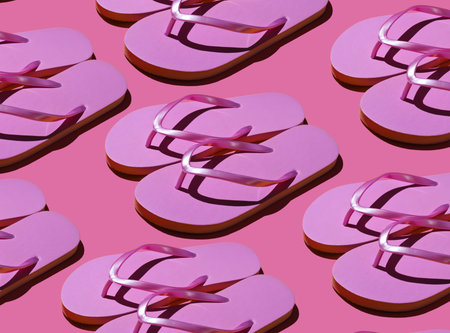 Beach vacation, summer background. Pop art style. A lot of pink flip flops on pink background. Fashion shot with shadows.の写真素材