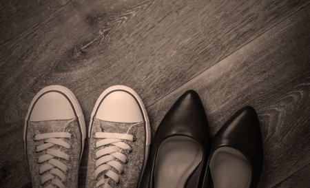 Women's leather shoes with heels, sneakers on the floor. Top viewの写真素材