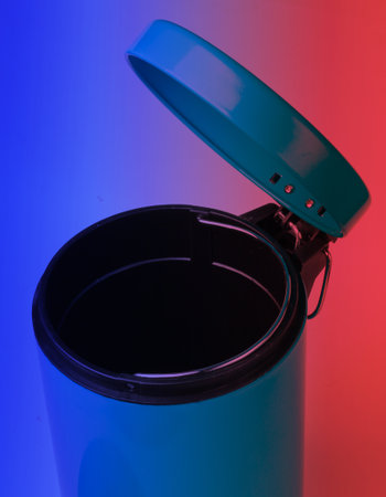 Open empty rubbish bin in neon lightの写真素材
