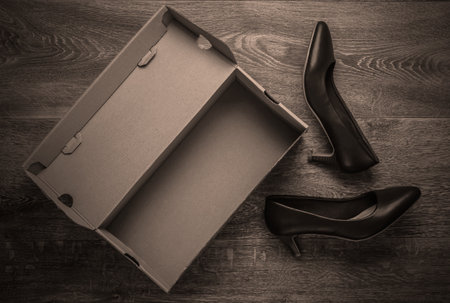 New leather heeled shoes with a cardboard box on the floor. Top viewの写真素材