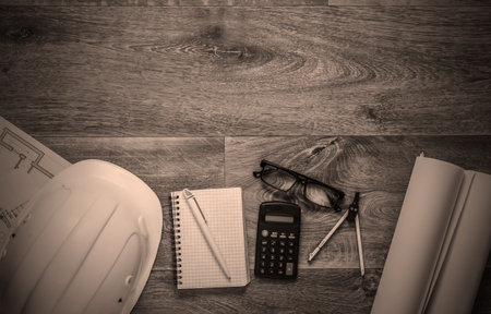 Creative layout of architects with roll drawings, engineering tools and stationery on floor, workspace. Top view. Flat lay. Copy spaceの写真素材